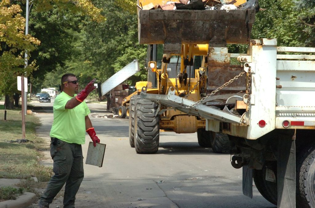workers cleaning a flooded street