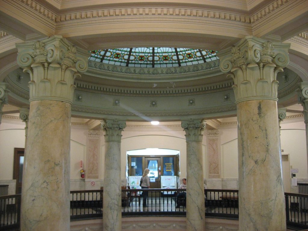 AI Copyright Cases Are Forcing Courts to Define Machine Creativity Classical courthouse pillars against a blue sky